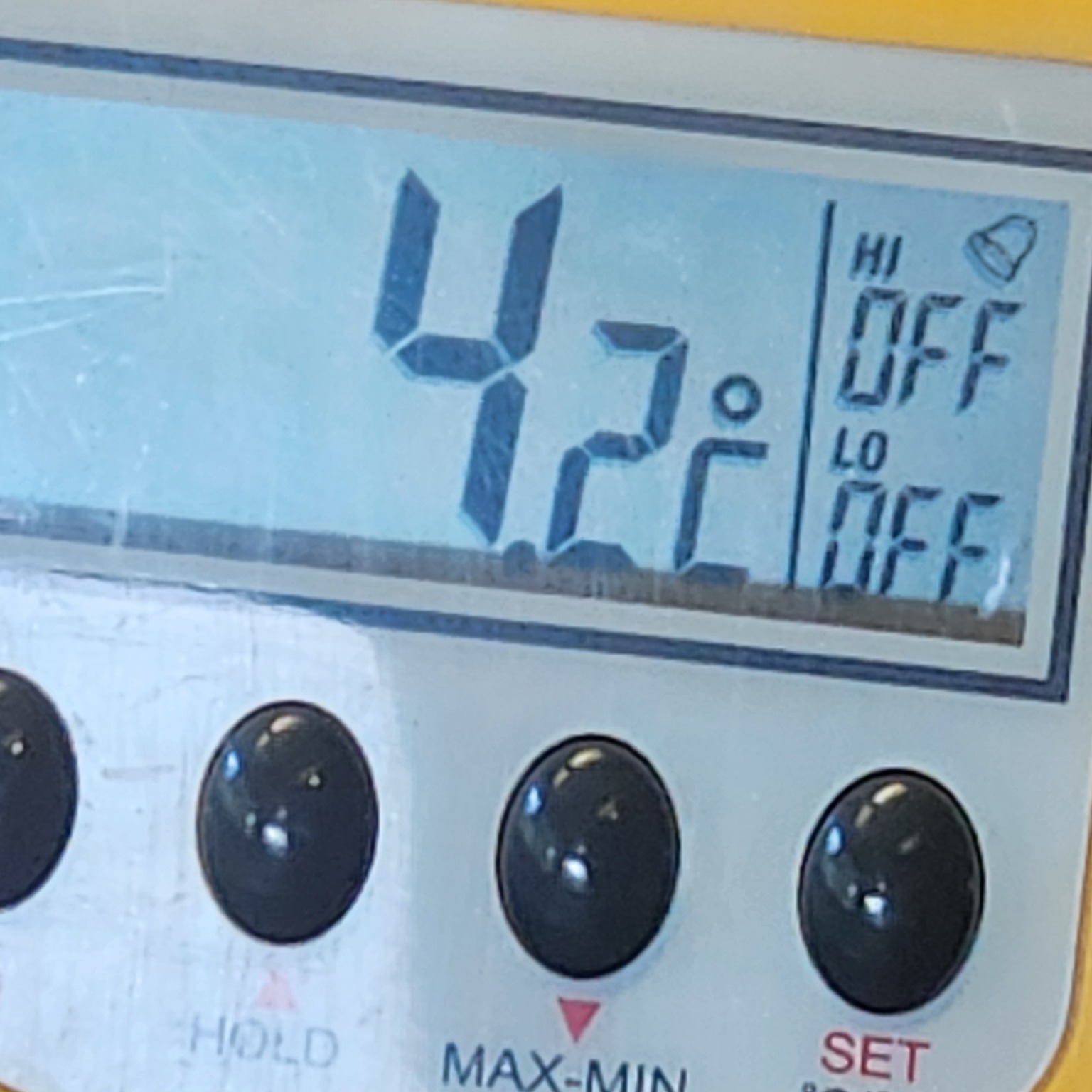 A digital thermometer reading 4.2 degrees at an air-con vent